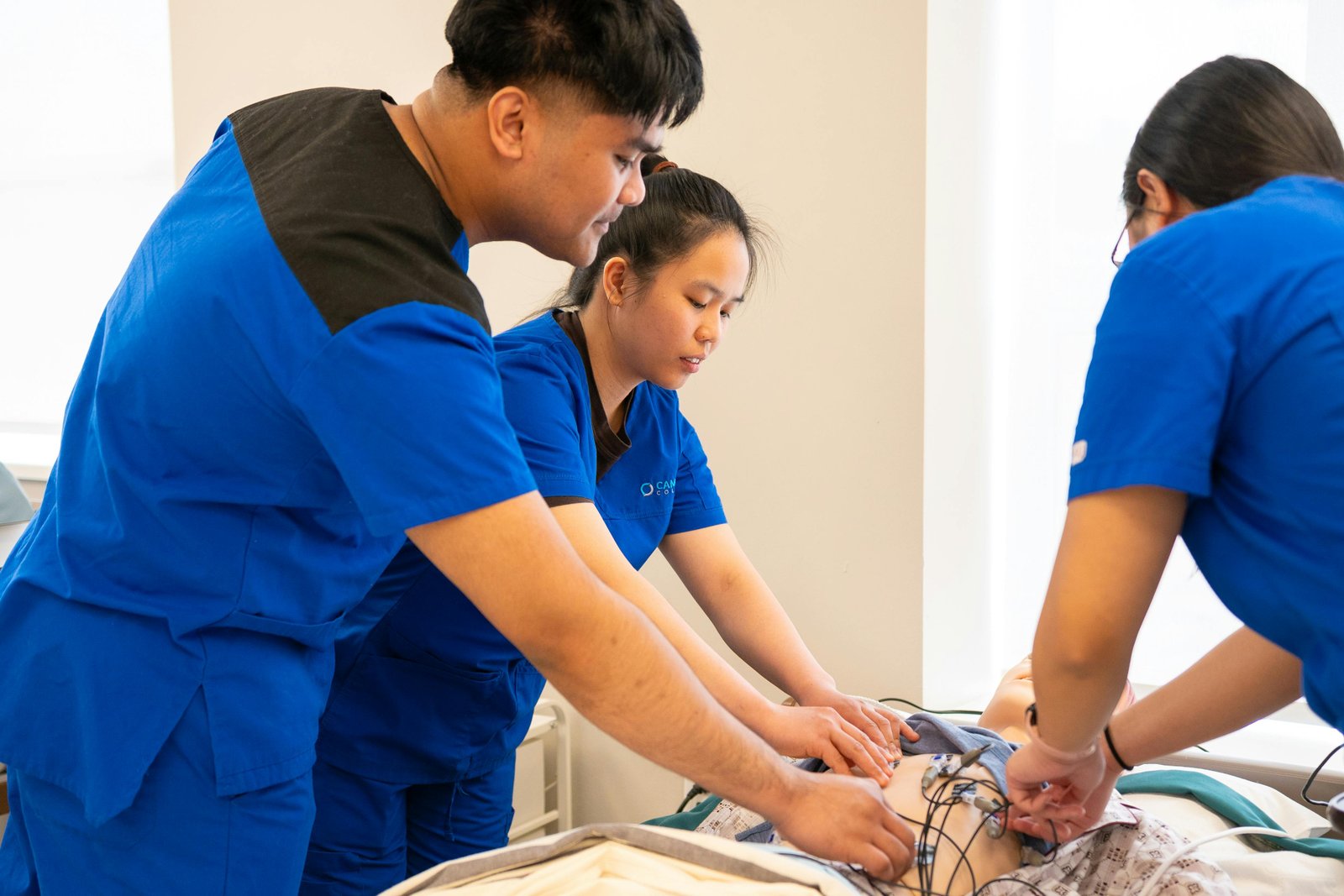 Student nurse reviewing charts in clinical setting.